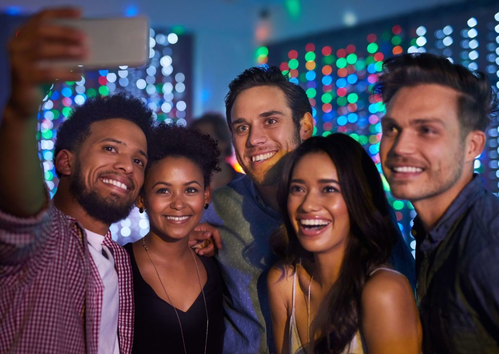 A group of men and women enjoying the Cayman Islands nightlife.
