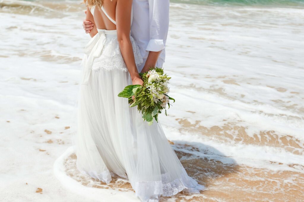 A woman and a man enjoying a Simple Beach Wedding.