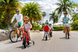 A family riding on a Bike Rental on Grand Cayman.