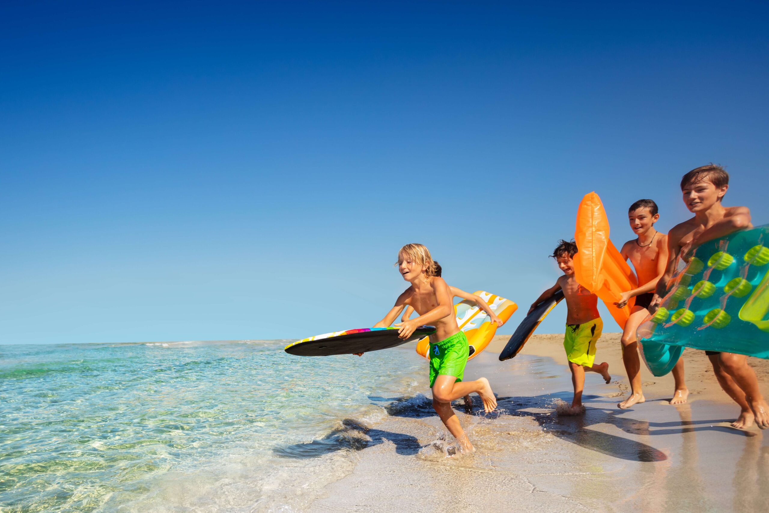 A group of children enjoying Grand Cayman Beaches.