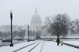 A snowy scene in Washington, D.C., with iconic landmarks dusted in white, highlighting the contrast between winter in the capital and sunny getaways to Grand Cayman