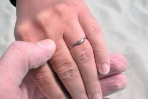 A hand with a wedding ring on it following a Caribbean Destination Wedding.